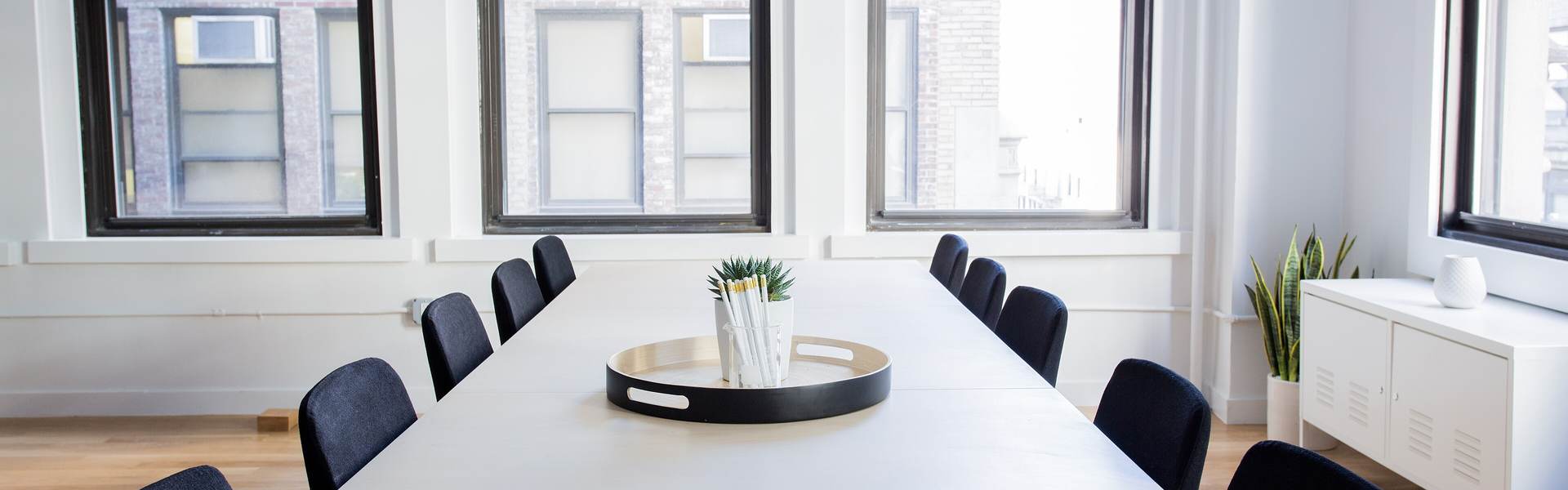 Bright meeting room with a long white table