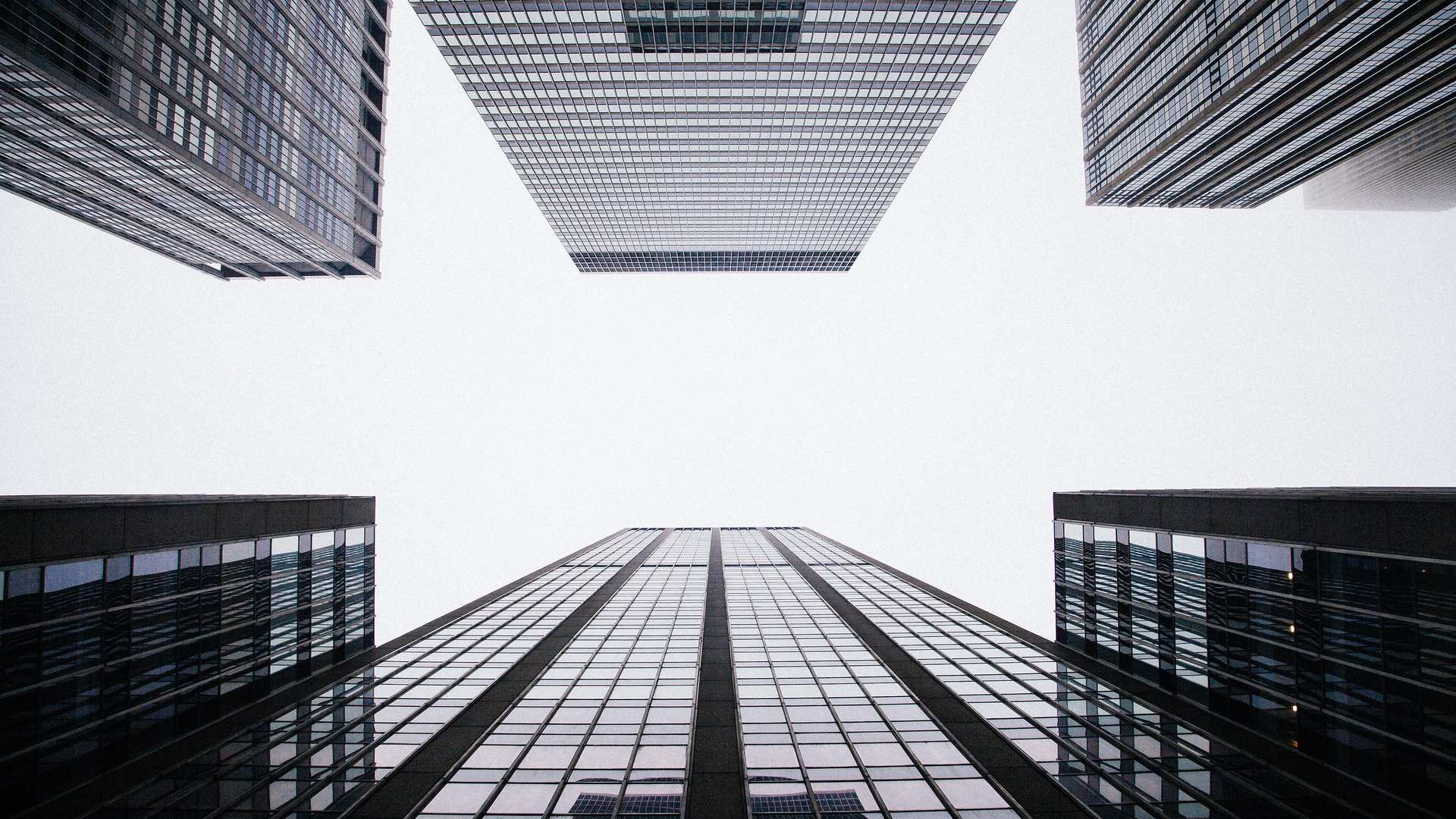Looking up at modern glass office towers